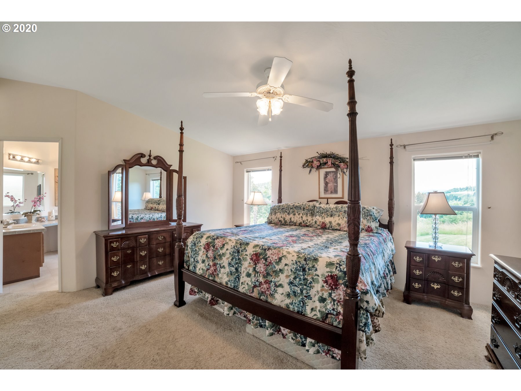 6990 Northwest Canyonview Road Gaston, OR 97119 - Photo 12 of 32 a bedroom with a bed a dresser next to a window