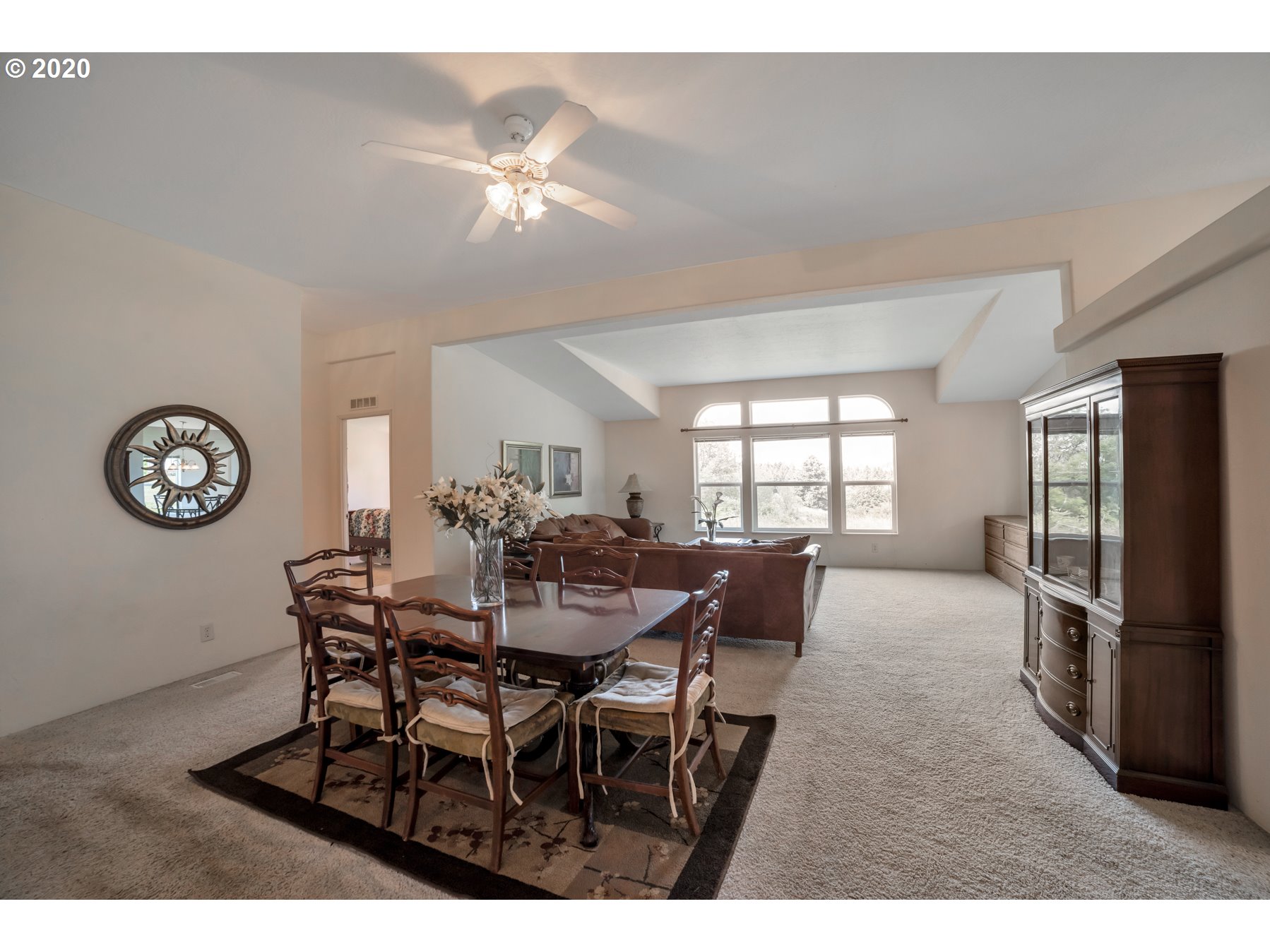 6990 Northwest Canyonview Road Gaston, OR 97119 - Photo 10 of 32 a view of a dining room with furniture and a chandelier