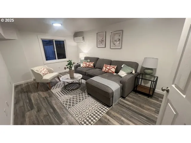 a living room with furniture and a rug