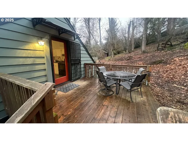 a backyard of a house with table and chairs