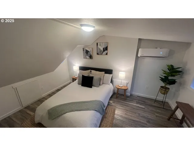 a bedroom with a bed and a potted plant