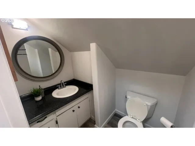 a bathroom with a sink mirror and toilet