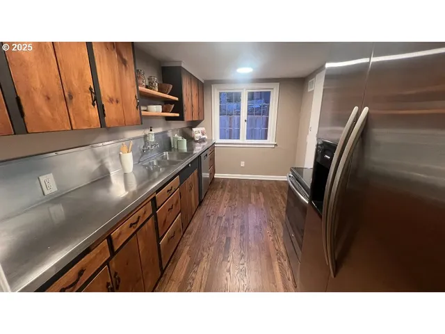 a open kitchen with sink and refrigerator
