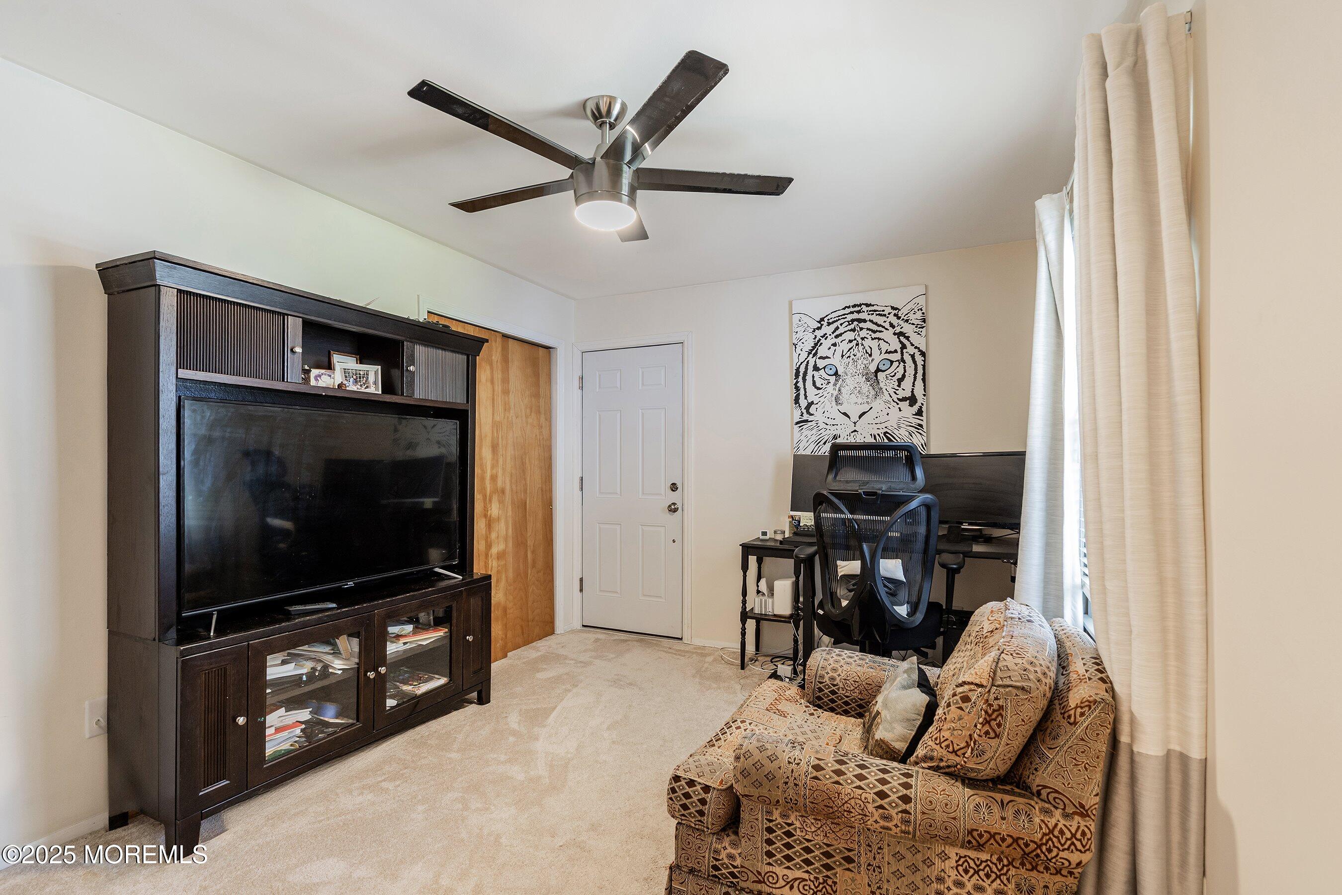 718 Millbrook Road Brick, NJ 08724 - Photo 11 of 26 a living room with furniture and a flat screen tv