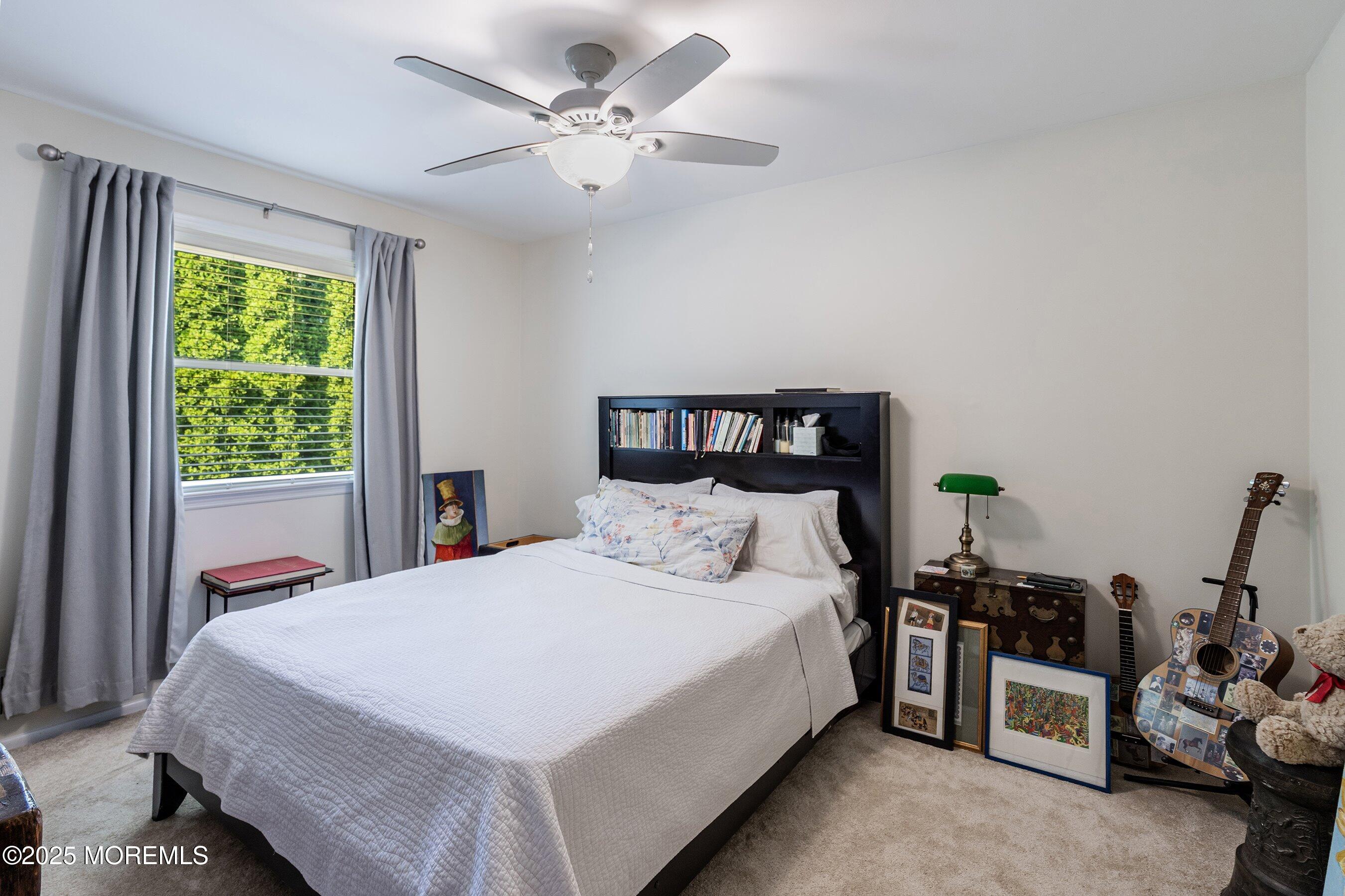 718 Millbrook Road Brick, NJ 08724 - Photo 12 of 26 a bedroom with a bed and a chandelier