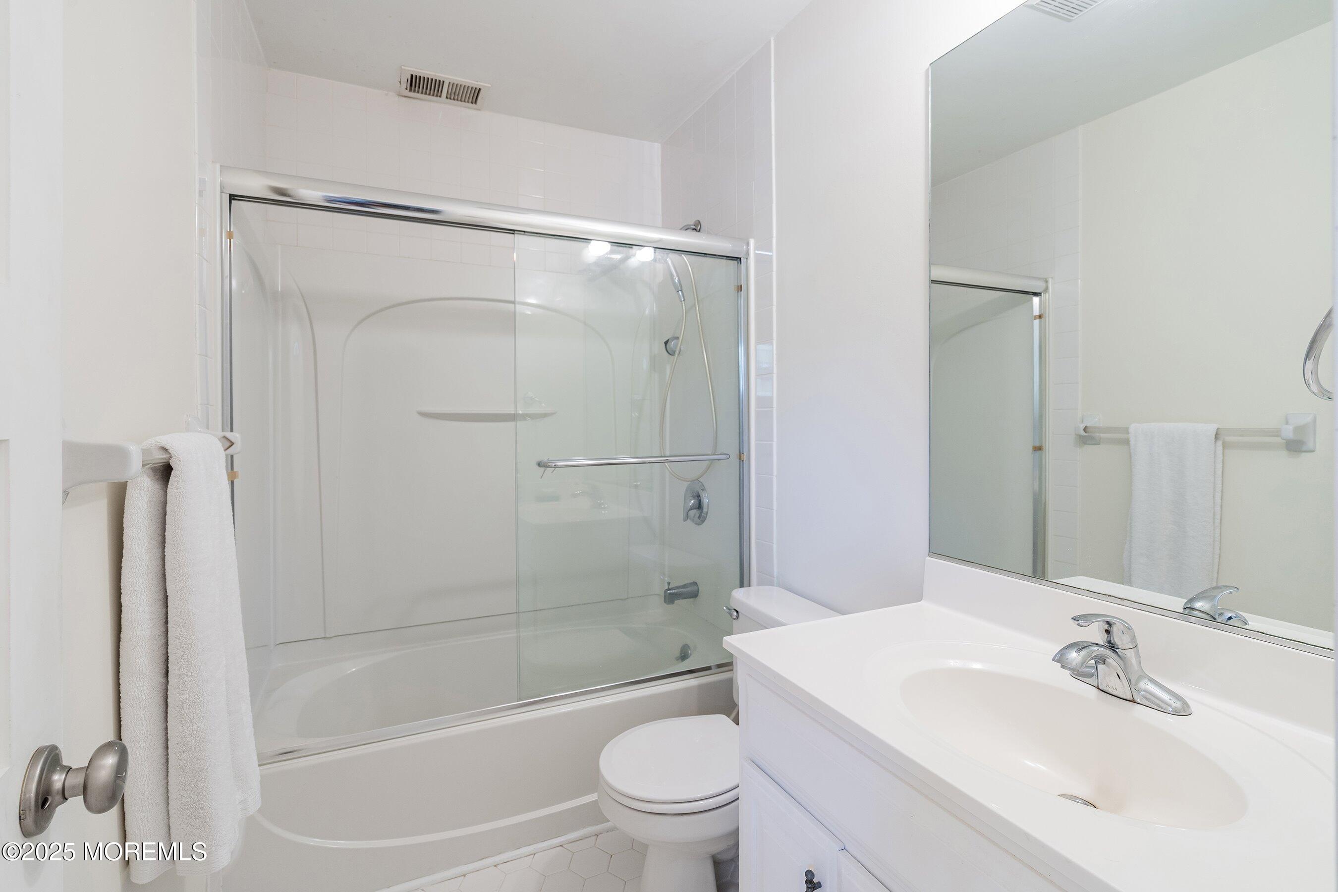718 Millbrook Road Brick, NJ 08724 - Photo 14 of 26 a bathroom with a bathtub shower sink vanity and toilet