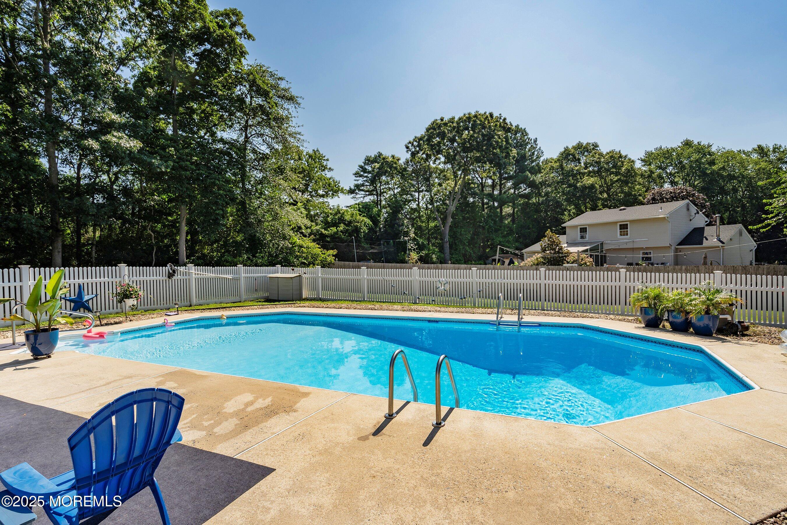 718 Millbrook Road Brick, NJ 08724 - Photo 18 of 26 a view of a swimming pool with a lounge chair