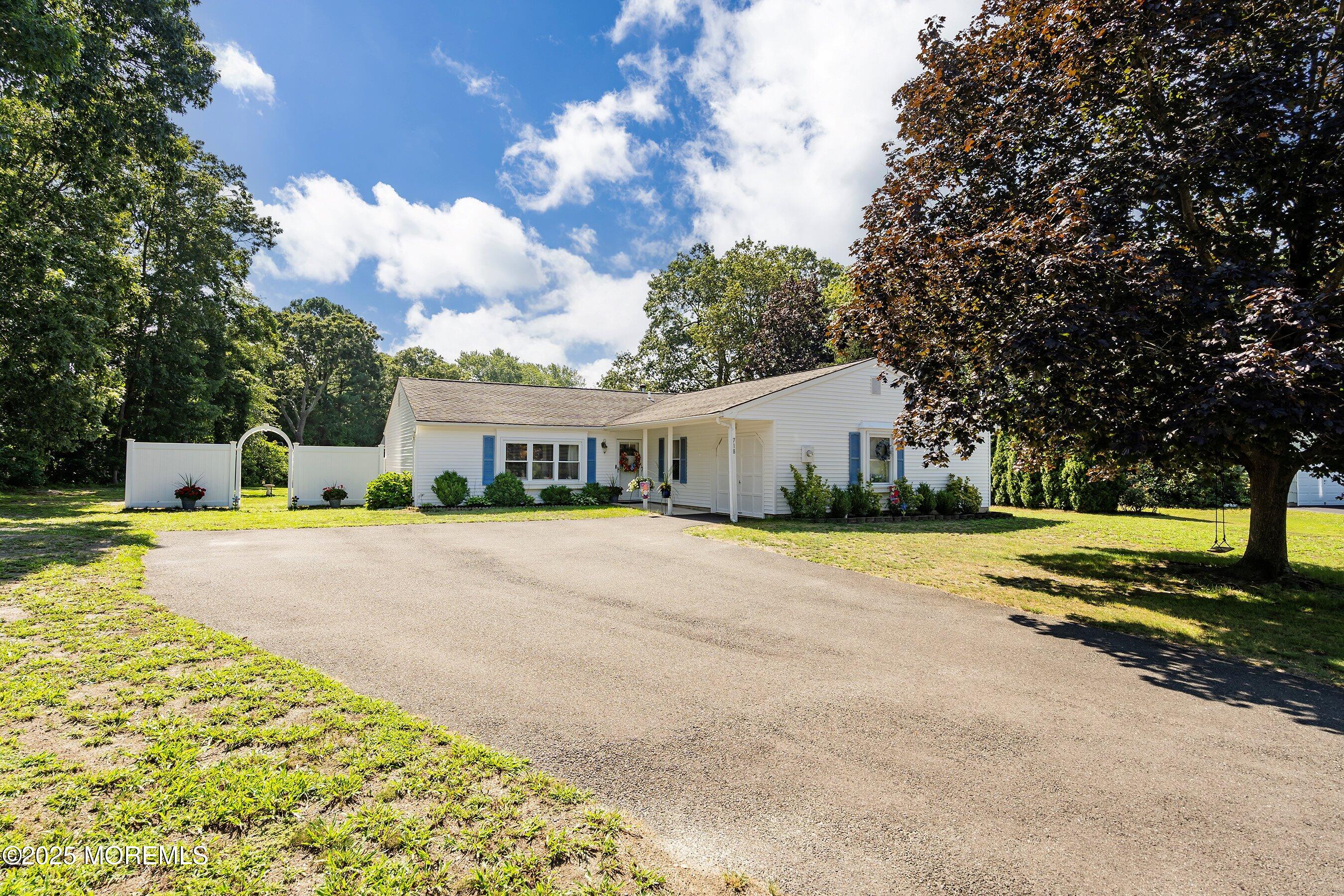 718 Millbrook Road Brick, NJ 08724 - Photo 3 of 26 a front view of a house with a yard and trees