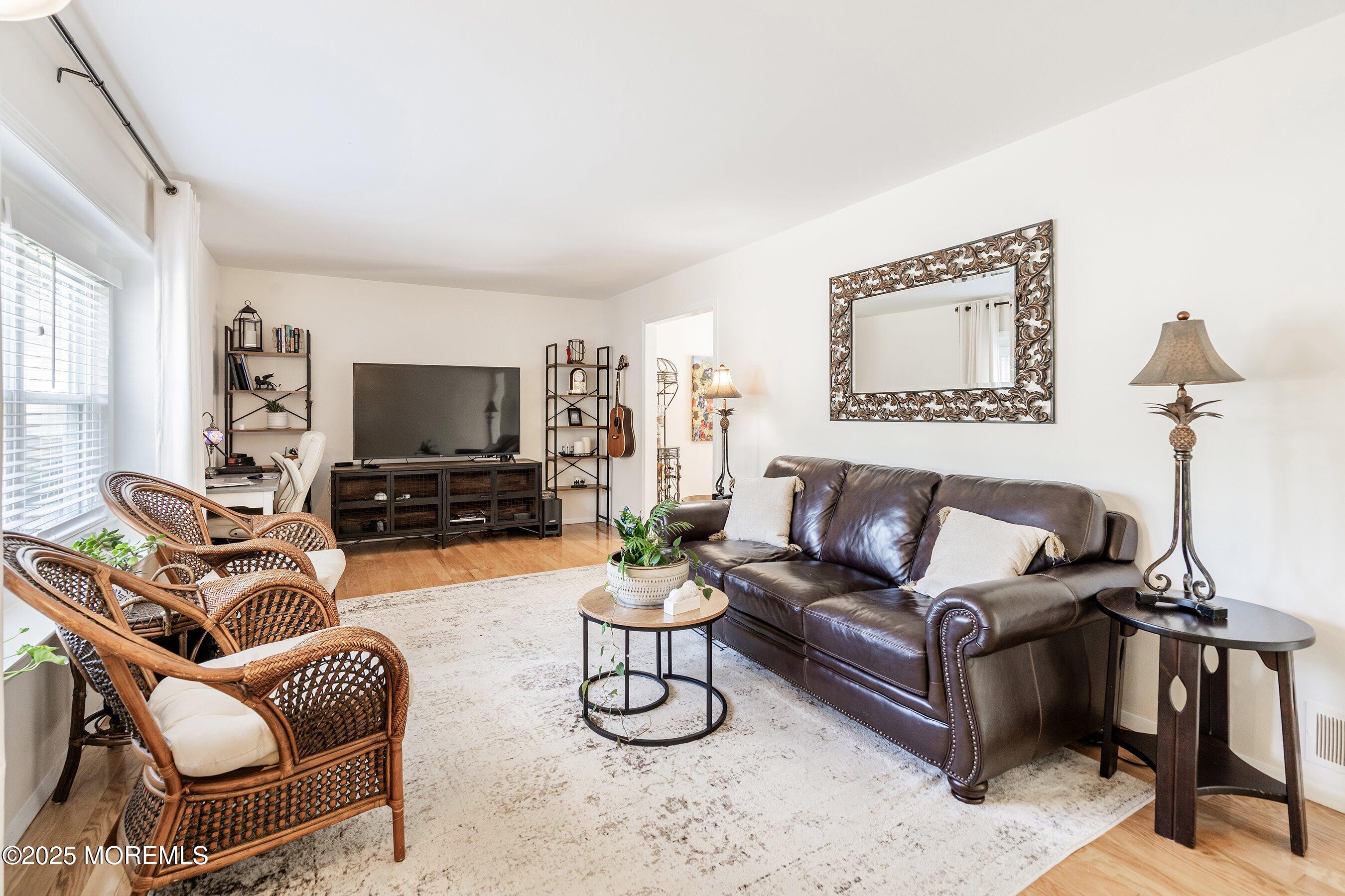 718 Millbrook Road Brick, NJ 08724 - Photo 4 of 26 a living room with furniture a flat screen tv and a window