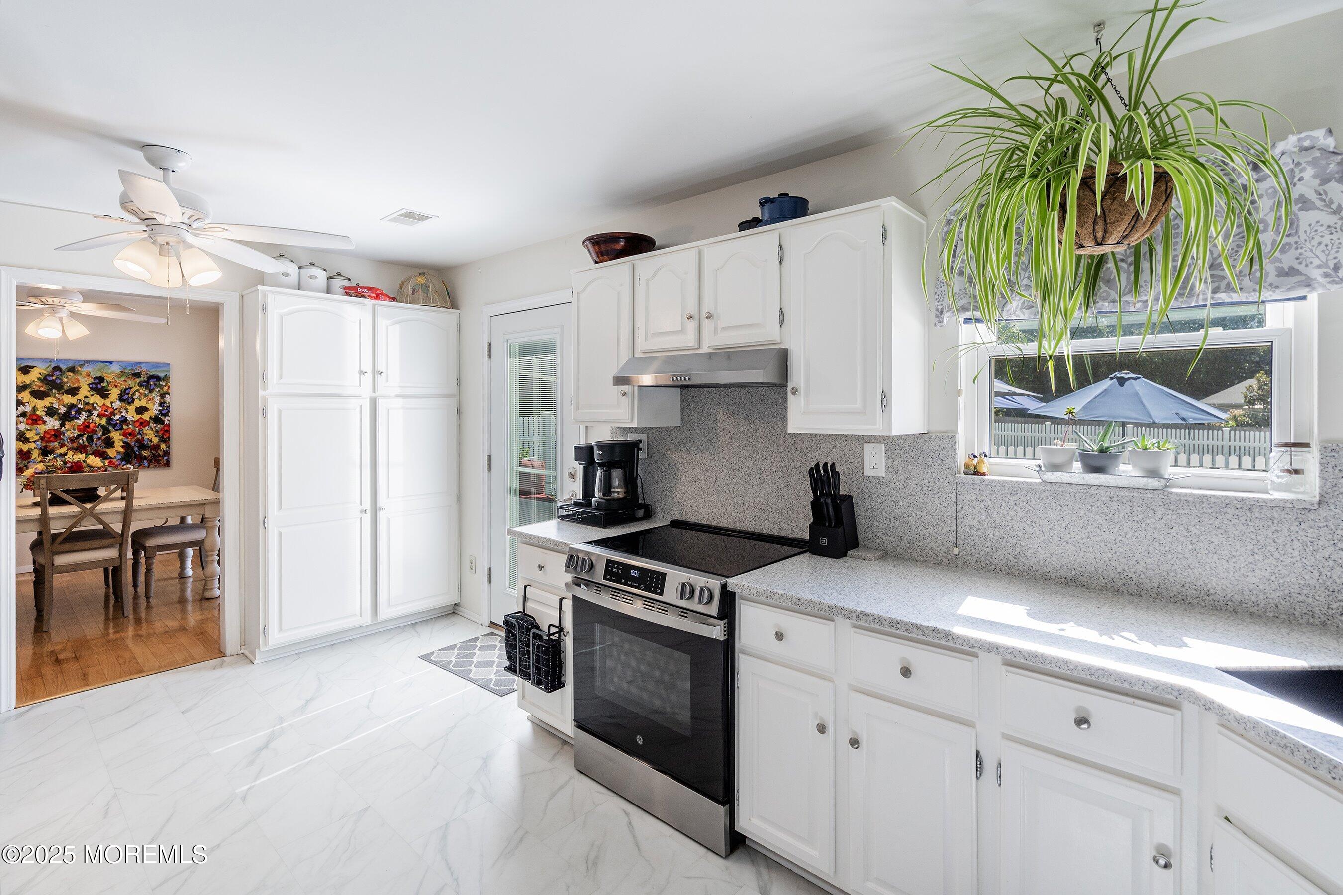 718 Millbrook Road Brick, NJ 08724 - Photo 8 of 26 a kitchen with granite countertop a stove a sink and a refrigerator