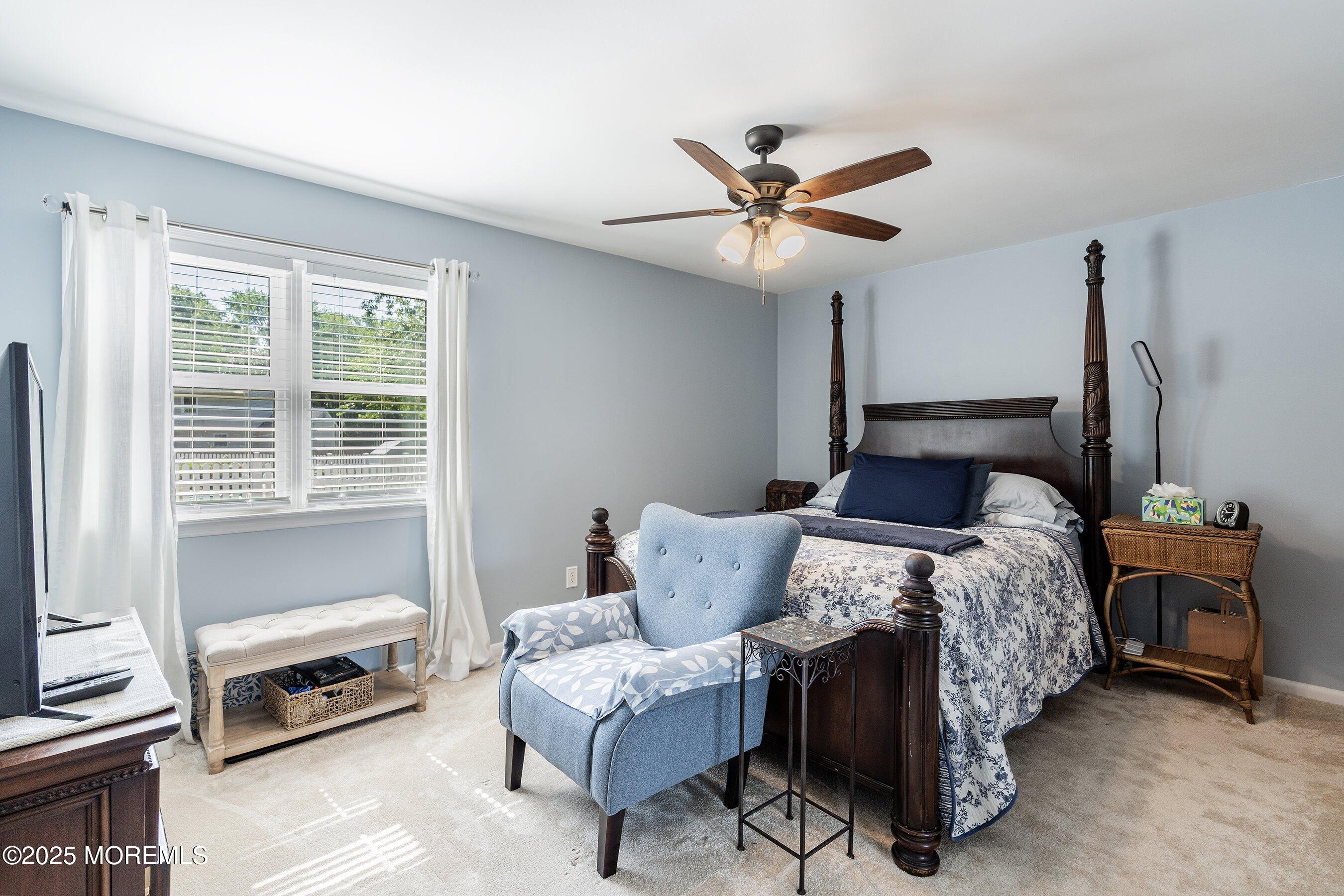 718 Millbrook Road Brick, NJ 08724 - Photo 9 of 26 a bedroom with a bed and a chandelier