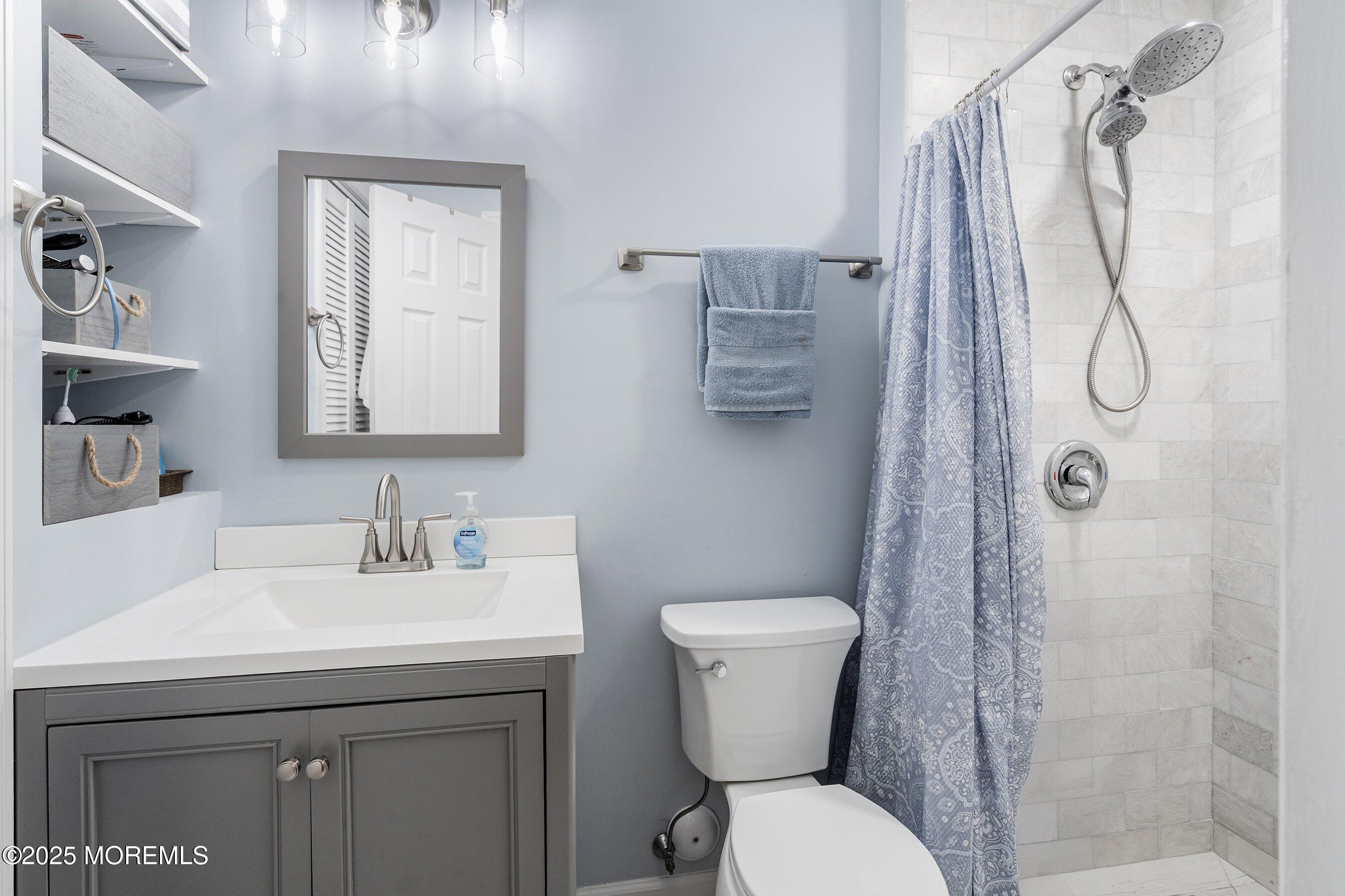 718 Millbrook Road Brick, NJ 08724 - Photo 10 of 26 a bathroom with a toilet sink and shower