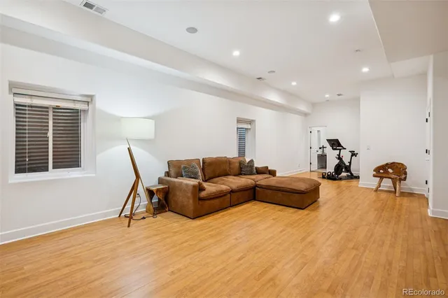 a living room with furniture and a wooden floor