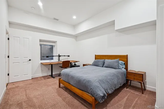 a bedroom with bed and a table