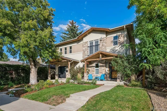 a view of a house with a yard and sitting area