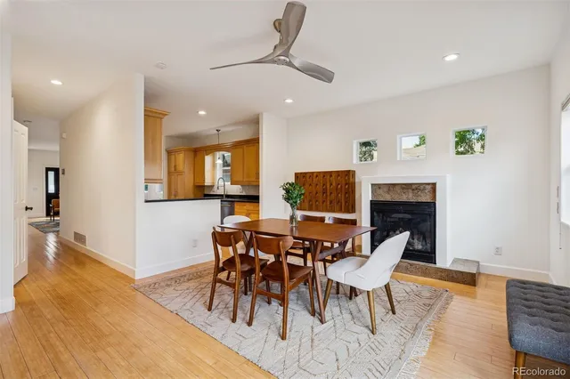 a dining room with furniture a rug and a fireplace