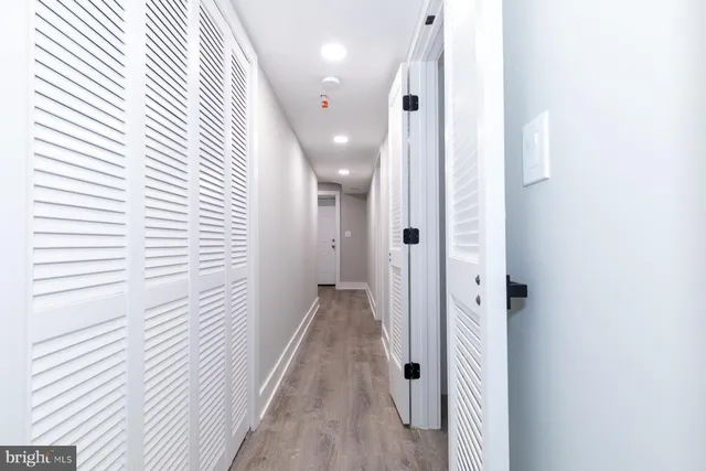 a view of a hallway with wooden floor