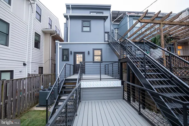 a view of a house with a wooden deck stairs and wooden floor