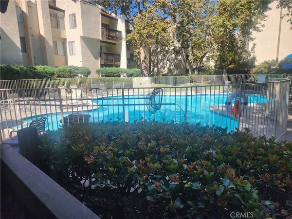 a view of a street with lots of bushes and trees