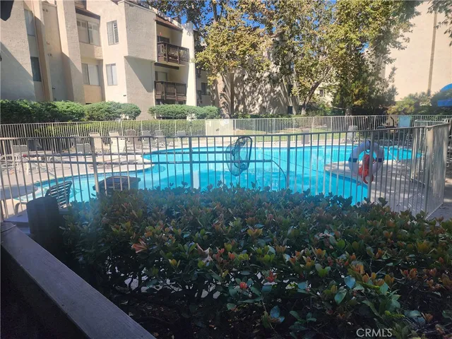 a view of a street with lots of bushes and trees