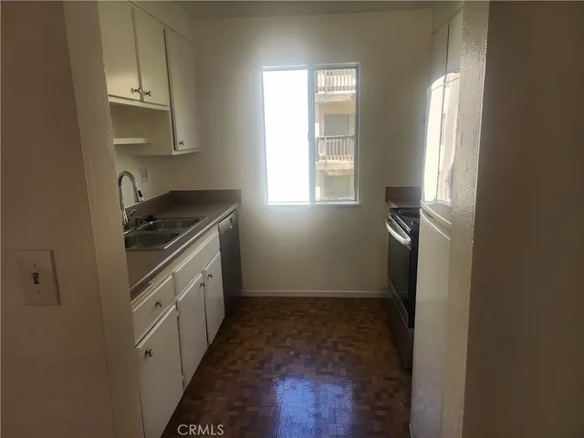 a kitchen with cabinets and window