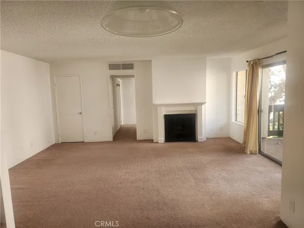 an empty room with fireplace