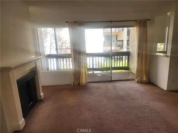 a view of an empty room with a fireplace