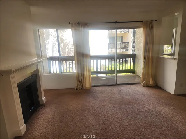 a view of an empty room with a fireplace