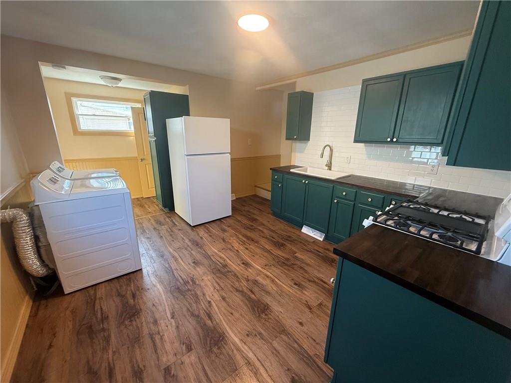 302 Neubert Street Kittanning, PA 16201 - Photo 11 of 23 a kitchen with stainless steel appliances granite countertop a refrigerator stove and a wooden floors