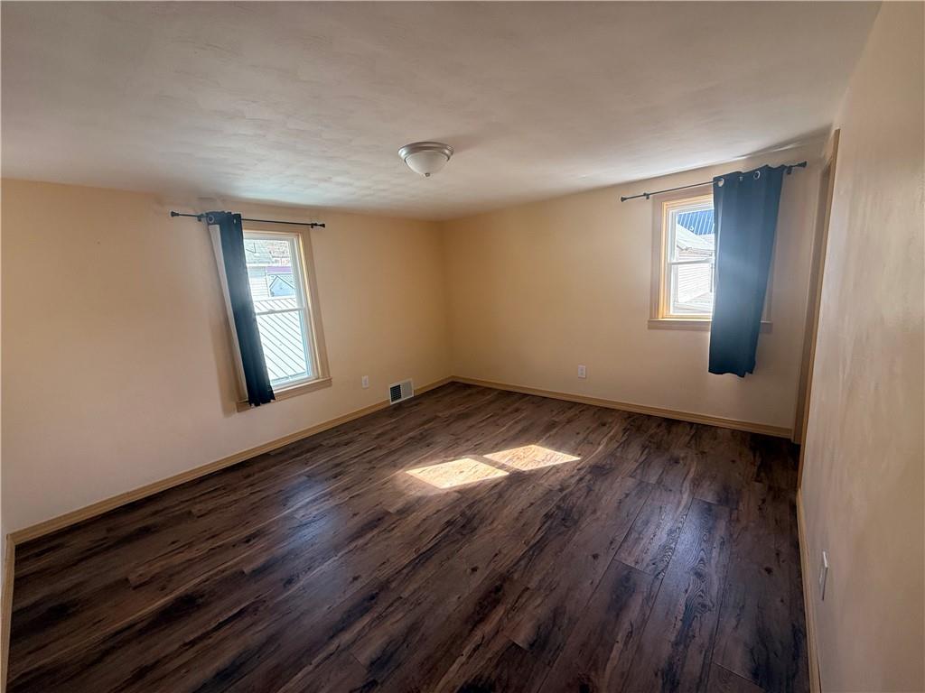 302 Neubert Street Kittanning, PA 16201 - Photo 13 of 23 an empty room with wooden floor and windows