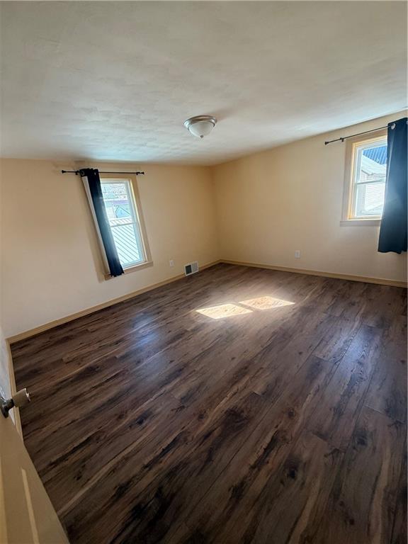 302 Neubert Street Kittanning, PA 16201 - Photo 14 of 23 a view of an empty room with wooden floor and a window