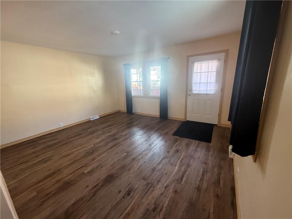 302 Neubert Street Kittanning, PA 16201 - Photo 16 of 23 an empty room with wooden floor and windows