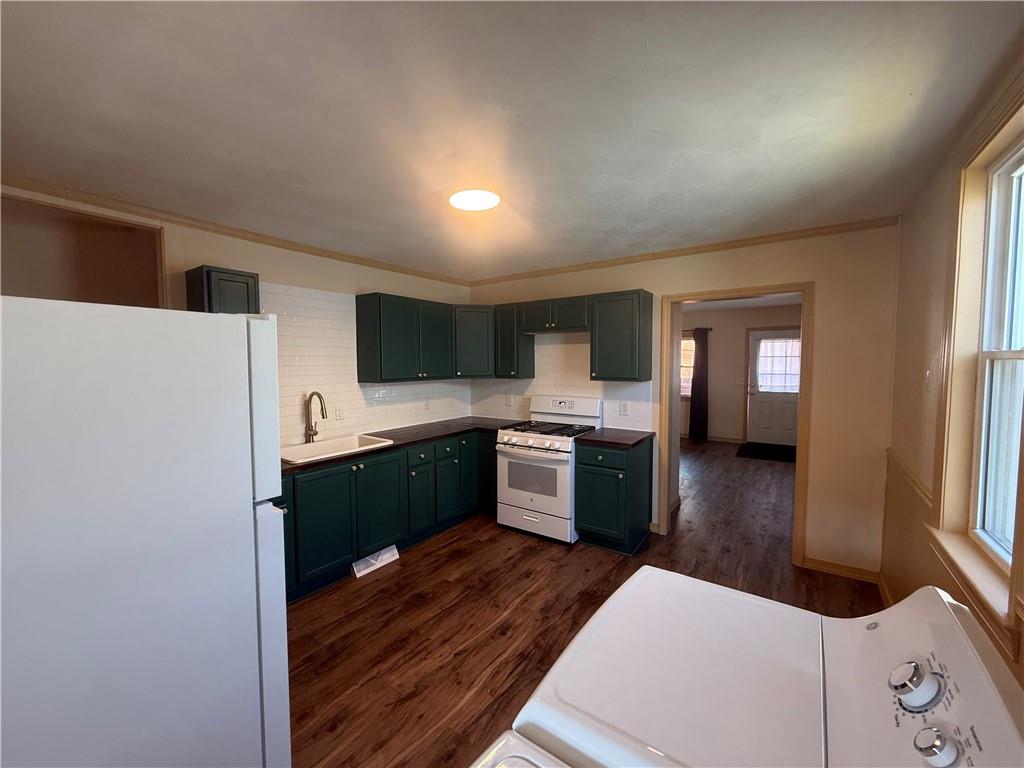 302 Neubert Street Kittanning, PA 16201 - Photo 3 of 23 a kitchen with stainless steel appliances kitchen island wooden cabinets and granite counter tops