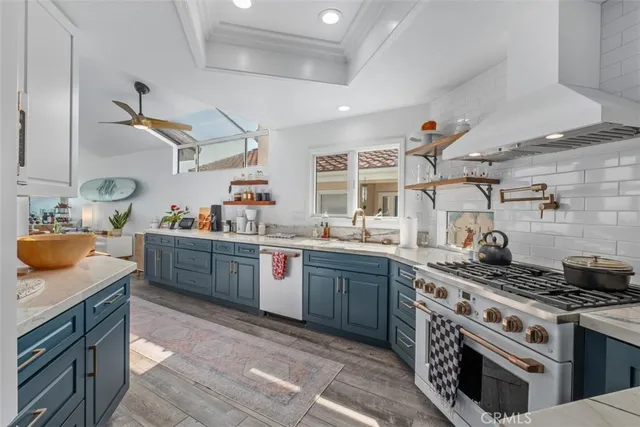 a kitchen with stainless steel appliances granite countertop a stove and a sink