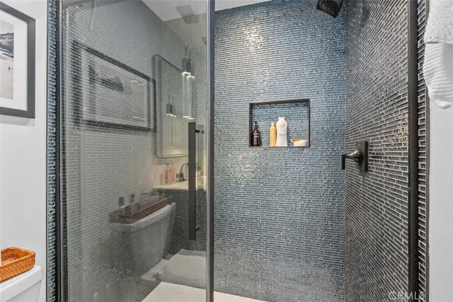 a bedroom with a bed and a mirror