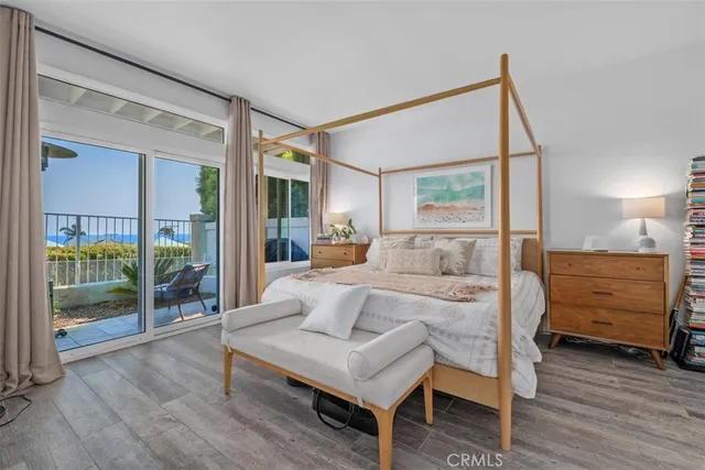 a bedroom with a large bed and a large window