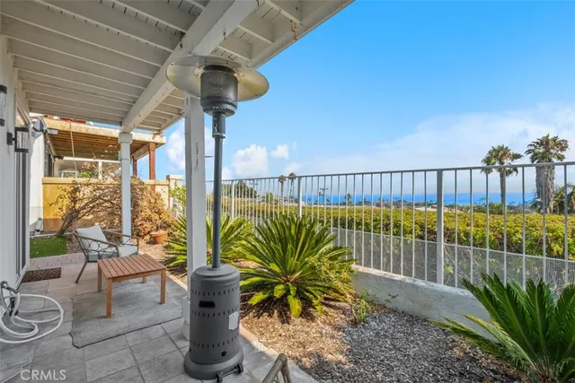 a balcony with furniture and a potted plant