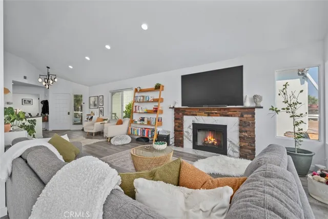 a living room with furniture a fireplace and a flat screen tv