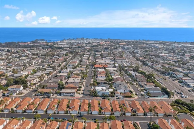 a front view of a house with garage and plants
