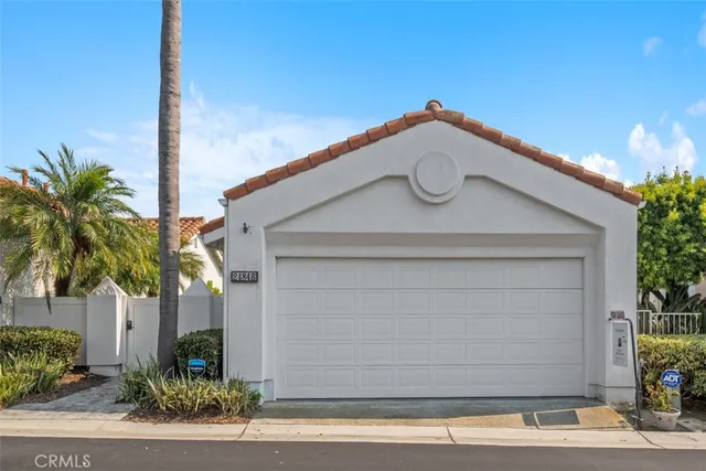 a house with potted plants in front of it