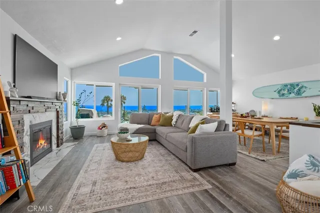 a living room with furniture a fireplace and a flat screen tv