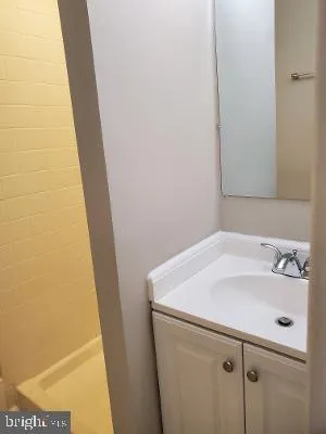 a view of a bathroom with a glass door and a wooden floor