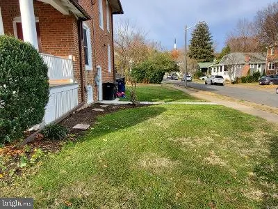 a view of street with houses and trees in the background