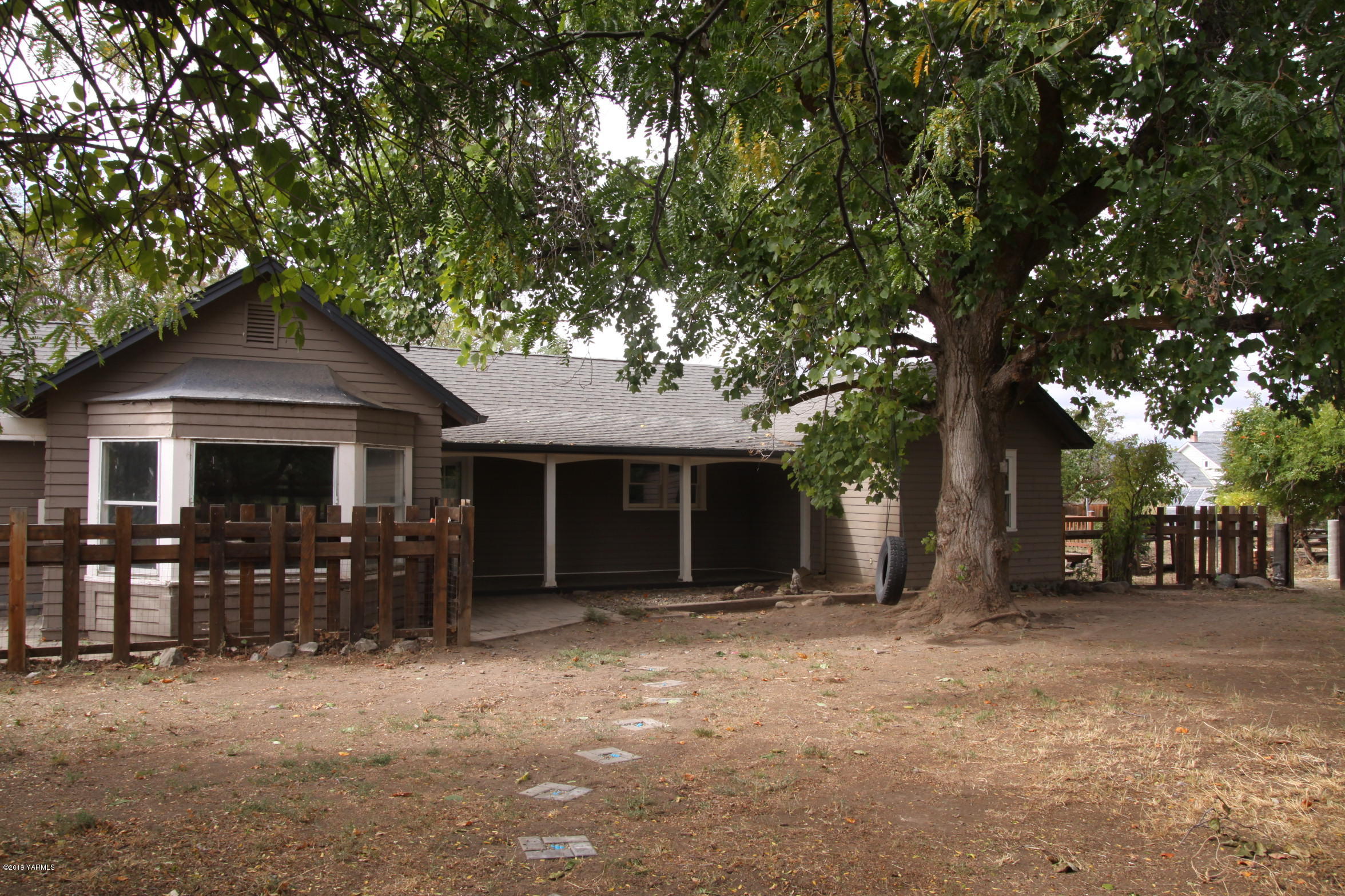 741 McPhee Road Naches, WA 98937 - Photo 1 of 16 a front view of a house with a tree