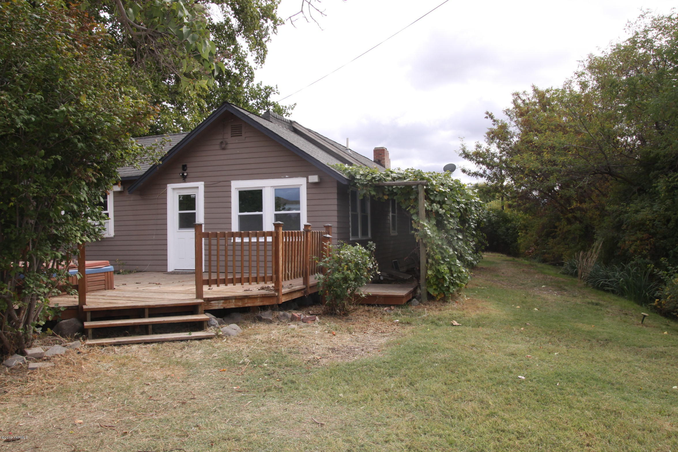 741 McPhee Road Naches, WA 98937 - Photo 14 of 16 a view of a house with a yard plants and large tree