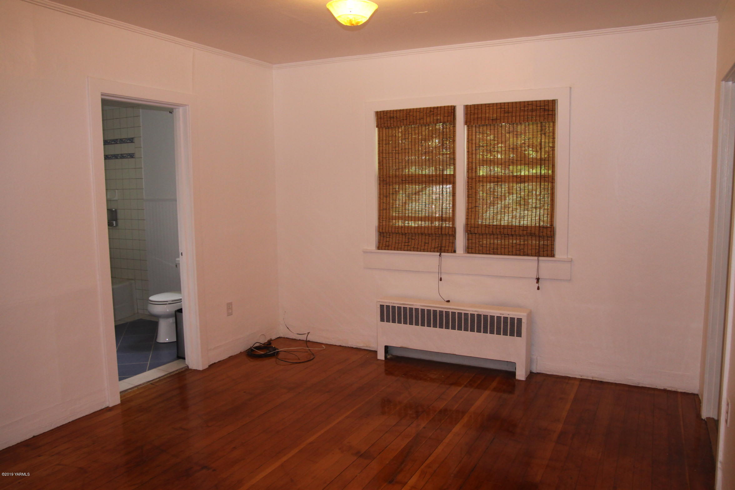 741 McPhee Road Naches, WA 98937 - Photo 6 of 16 an empty room with wooden floor and windows
