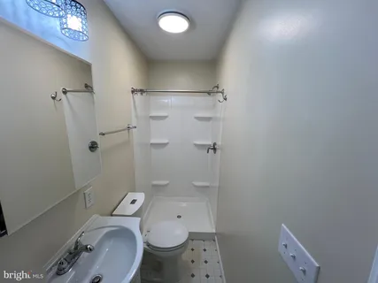 a bathroom with a granite countertop toilet a sink and shower