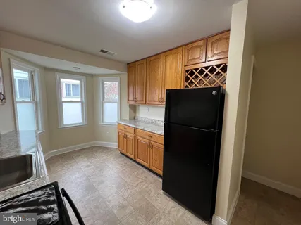 a kitchen with granite countertop white refrigerator and a stove