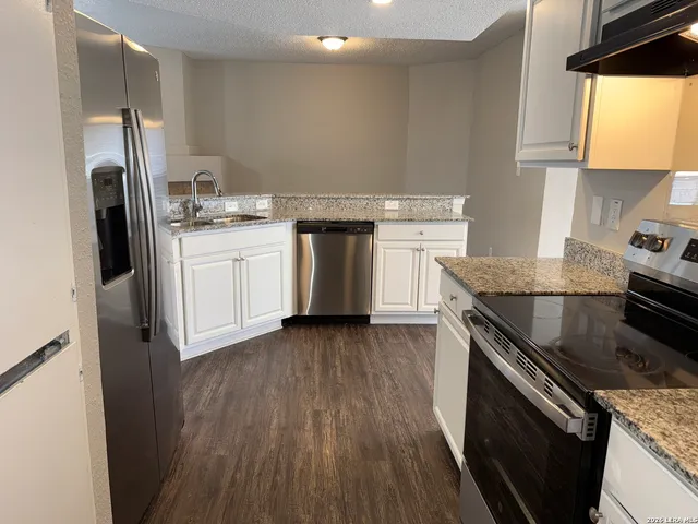 a kitchen with a sink stove and refrigerator
