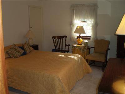 240 Cedric Road Centerville, MA 02632 - Photo 8 of 10 a bed room with a bed and a lamp